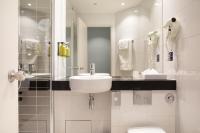 a white bathroom with a sink and a toilet at Holiday Inn Express Amiens, an IHG Hotel in Amiens