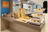a bakery counter with bread and other food items at Holiday Inn Express Amiens, an IHG Hotel in Amiens