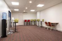 a room with chairs and tables in a room at Holiday Inn Express Amiens, an IHG Hotel in Amiens