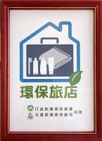 a sign in a frame with a picture of a house at Lantian Baiyun in Hualien City