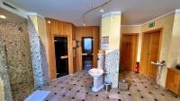 a bathroom with a toilet in the middle of a room at Pension Weinberger in Obertauern