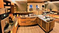 a large kitchen with wooden cabinets and a counter at Pension Weinberger in Obertauern