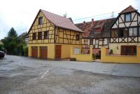 a yellow and black house on a street at la grange in Wintzenheim