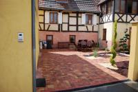 an outside view of a house with a brick patio at la grange in Wintzenheim