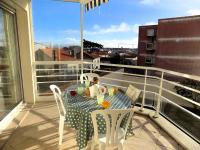 a table and chairs on a balcony with a view at Royan - Résidence VILLA BRACELLI - APPARTEMENT SPACIEUX - Centre-ville in Royan