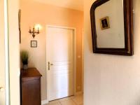 a hallway with a mirror and a white door at Royan - Résidence VILLA BRACELLI - APPARTEMENT SPACIEUX - Centre-ville in Royan