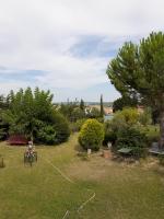 a person is sitting in a yard with a rope at Petit Paradis chez Pascale et Bernard in Cazouls-lès-Béziers