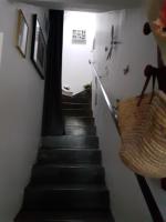 a hallway with a staircase with a basket on the wall at Petit Paradis chez Pascale et Bernard in Cazouls-lès-Béziers