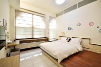 a bedroom with a large bed and a window at Jamie home stay in Taitung City