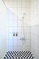 a bathroom with a shower with a black and white checkered floor at Jamie home stay in Taitung City