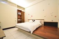 a bedroom with a large bed in a room at Jamie home stay in Taitung City