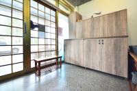 a locker room with a bench and large windows at Jamie home stay in Taitung City