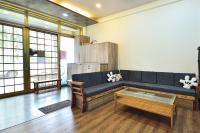 a living room with a blue couch and a coffee table at Jamie home stay in Taitung City