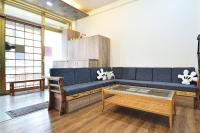 a living room with a blue couch and a coffee table at Jamie home stay in Taitung City