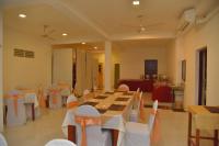 a large room with tables and chairs in it at Emarald Holiday Homes in Anuradhapura