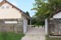 a house with a gate and a brick wall at Guest house avec spa Jura , gîte du petit pommier 
