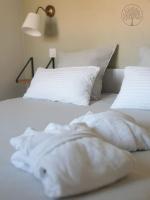 two white beds with white pillows in a bedroom at Guest house avec spa Jura , gîte du petit pommier 