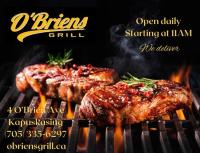 twee stukken vlees koken op een grill bij Travelodge by Wyndham Kapuskasing in Kapuskasing