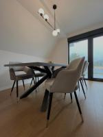 a dining room with a black table and chairs at Villa Anemar in Blidinje