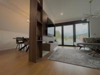 a living room with a table and a dining room at Villa Anemar in Blidinje