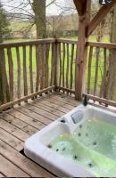 a jacuzzi tub sitting on a wooden deck at Cabane perchée luxe avec jacuzzi Domaine du Marais Maisse in Maisse