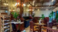 a restaurant with tables and chairs in a room at Harmony Indochine d'Angkor in Siem Reap