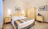 a bedroom with a large bed and two night stands at Hotel Torino in Venice