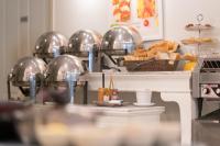 a kitchen with a counter with bread and food at The Verandah - SHA Extra Plus in Ao Nang Beach