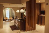 a lobby with a reception desk and a living room at Konventa Sēta Hotel Keystone Collection in Riga