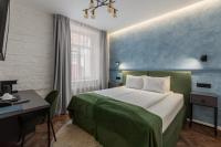 a hotel room with a bed and a desk and a bed at Konventa Sēta Hotel Keystone Collection in Riga