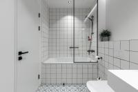 a bathroom with a shower with a tub and a sink at Konventa Sēta Hotel Keystone Collection in Riga