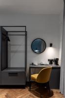 a desk with a yellow chair and a mirror at Konventa Sēta Hotel Keystone Collection in Riga