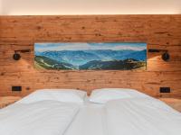 a bedroom with two beds with a picture on the wall at Apartment Das Georgen- Schmitten by Interhome in Fürstau