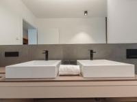 two white sinks on a counter in a bathroom at Apartment Das Georgen- Schmitten by Interhome in Fürstau