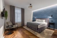 a bedroom with a bed and a blue wall at Konventa Sēta Hotel Keystone Collection in Riga