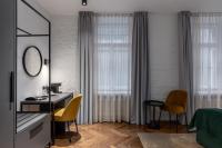 a bedroom with a desk and a bed and a mirror at Konventa Sēta Hotel Keystone Collection in Riga