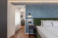 a bedroom with a large bed and a blue wall at Konventa Sēta Hotel Keystone Collection in Riga