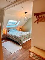 a bedroom with a bed in a attic at Vakantiehuis Maison Madeleine centrum Ieper in Ieper