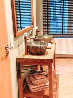 a bathroom with two sinks on a wooden counter at Vakantiehuis Maison Madeleine centrum Ieper in Ieper