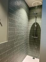 a bathroom with a shower with a shower head at Vakantiehuis Maison Madeleine centrum Ieper in Ieper