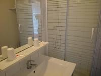 a white bathroom with a sink and a shower at Hotel TGV in Quimper