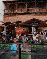 a group of people sitting at a restaurant at Konventa Sēta Hotel - Keystone Collection in Rīga