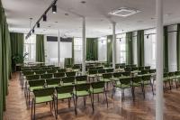 a conference room with green chairs and tables at Konventa Sēta Hotel Keystone Collection in Riga