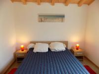 a bedroom with a blue bed with two candles on tables at Les Mathes La Palmyre - MAISON CABANE des TRAPPEURS - PROCHE COMMERCES in Les Mathes