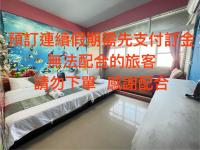 a bedroom with red writing on the wall at Rihchun Homestay in Hengchun South Gate