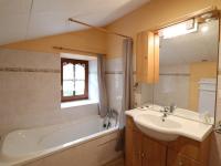 a bathroom with a sink and a bath tub and a sink at Gîte Sansac-Veinazès, 3 pièces, 4 personnes - FR-1-742-114 