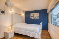 a bedroom with a bed and a blue wall at Spacious and cosy flat in Annecy