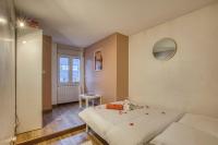 a bedroom with a bed with red rose petals on it at Spacious and cosy flat in Annecy