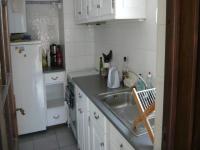 a kitchen with a sink and a white refrigerator at 4VSE-LAM55 Appartement avec vue dégagée Collioure proche plage in Collioure