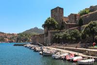 a group of boats docked in a river next to a castle at 4VSE-LAM55 Appartement avec vue dégagée Collioure proche plage in Collioure